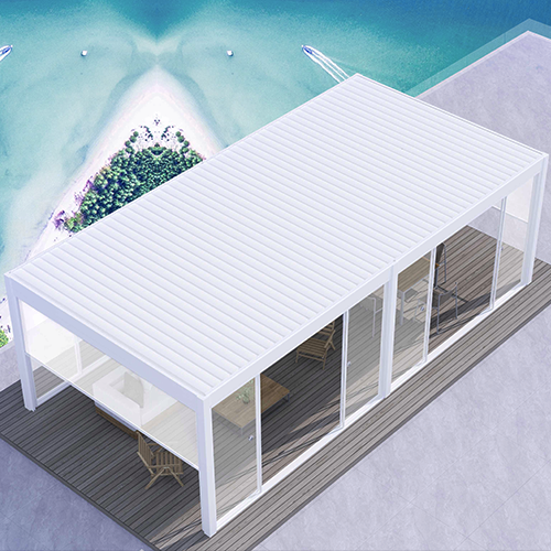 Modern white aluminum pergola patio cover with louvered roof and sliding glass doors on a seaside deck